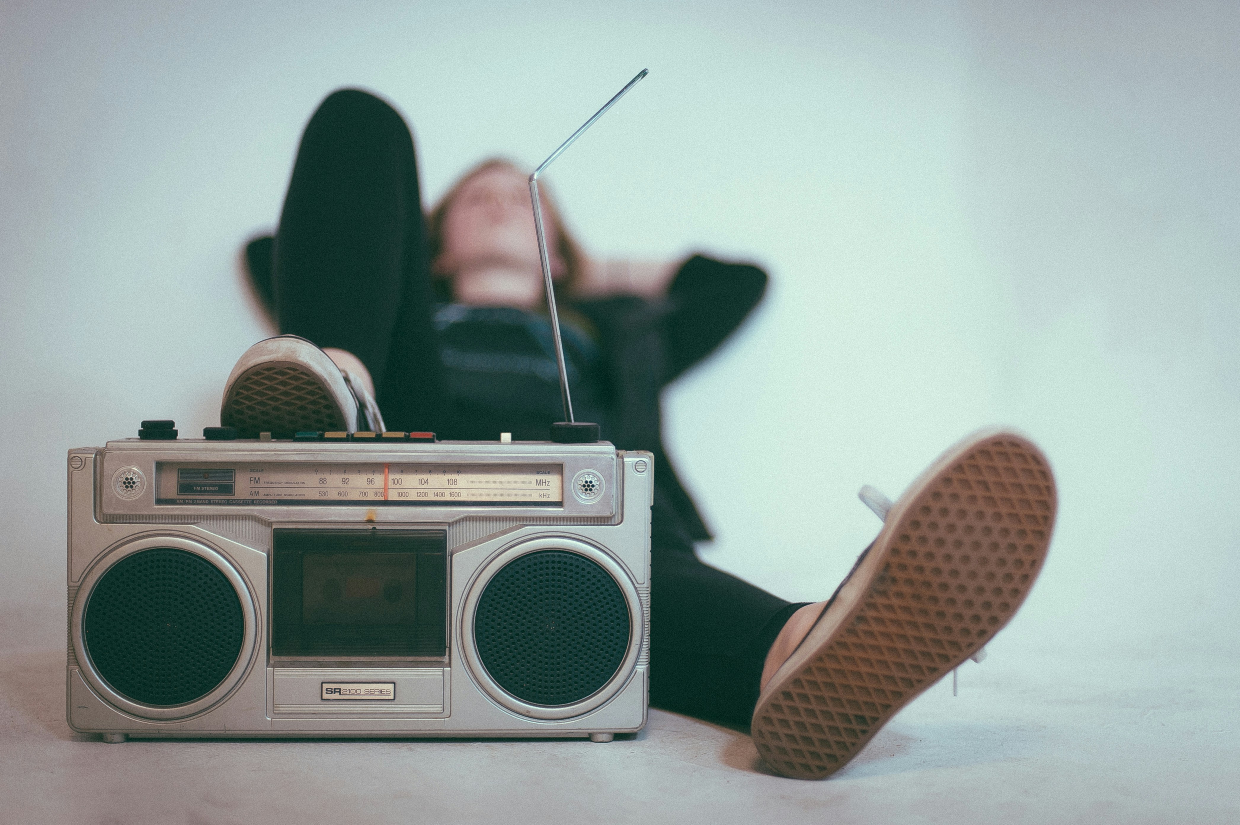 Person relaxing and listening to a boombox